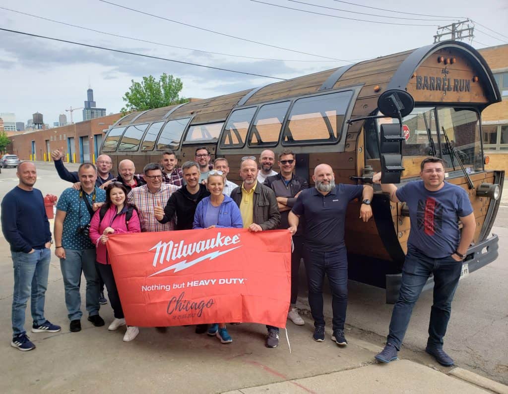 group of people on a corporate outing for Milwaukee Chicago in front of The Barrel Run bus