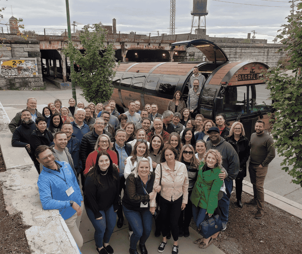 group of people in front of the barrel bus at a Chicago corporate event