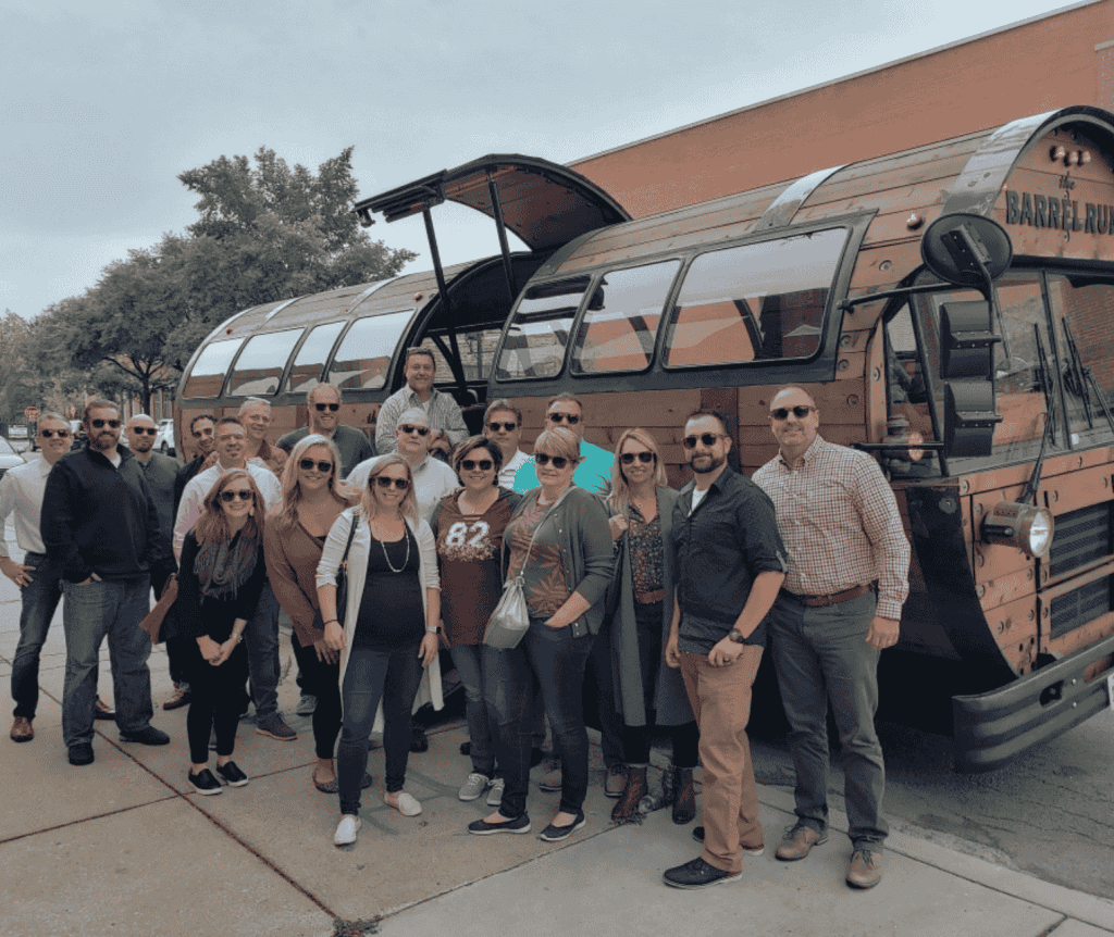 people standing in front of The Barrel Run bus at a Kentucky team building activity