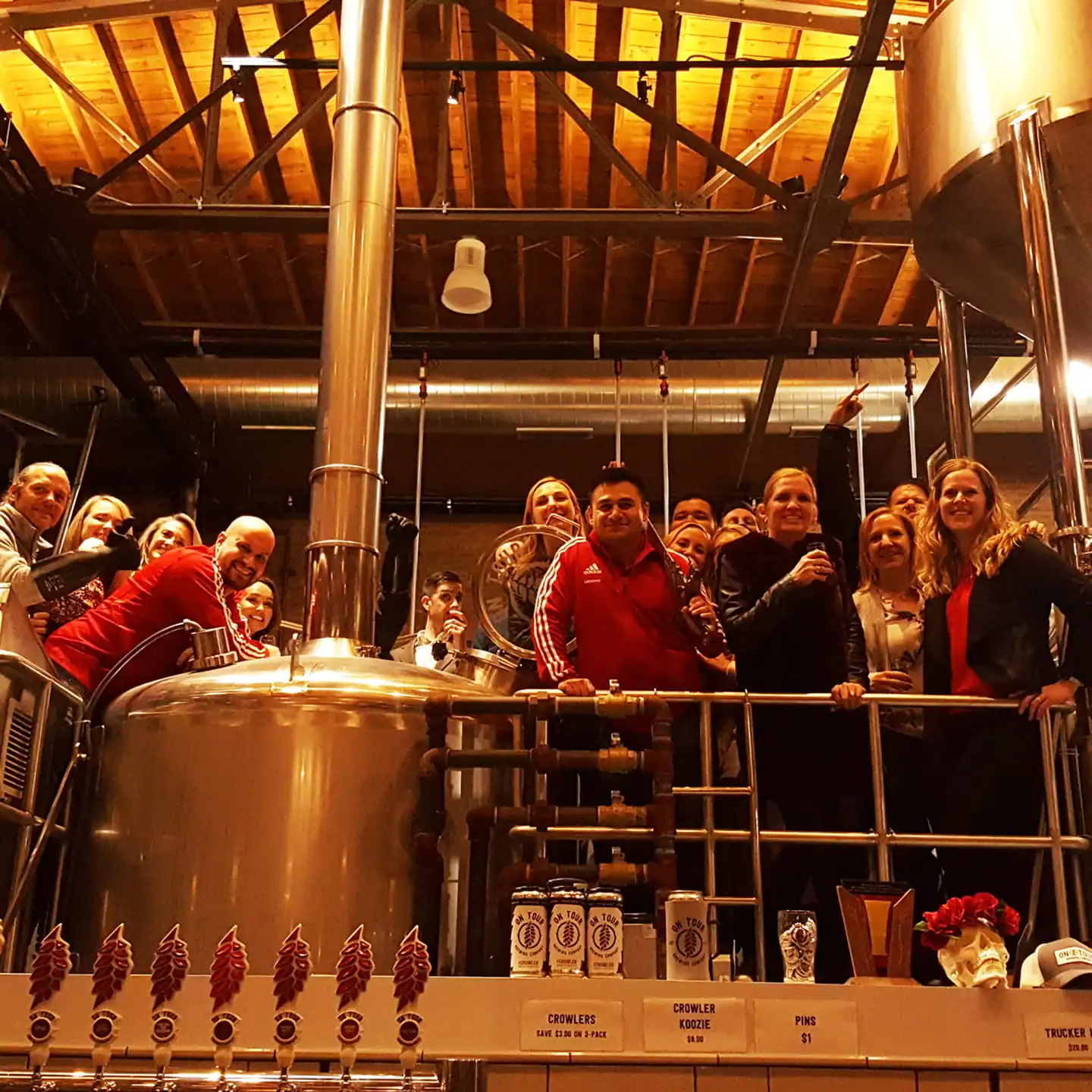 people standing next to brewing equipment on a public brewing tour in Chicago