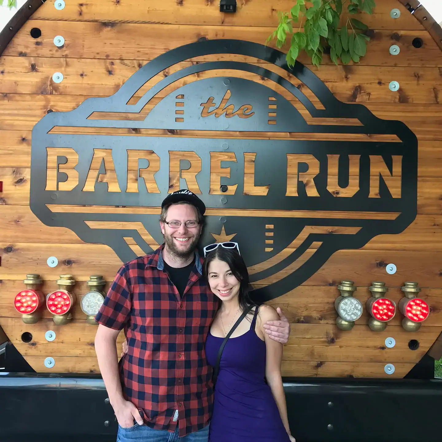 two people standing in front of The Barrel Run logo in Chicago